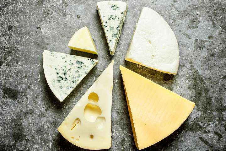 Various pieces of cheese around.